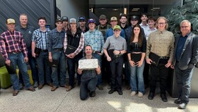 15 Heavy Equipment Technician pre-employment students stand with their instructor and Olds College leaders