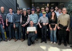 15 Heavy Equipment Technician pre-employment students stand with their instructor and Olds College leaders