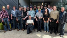 15 Heavy Equipment Technician pre-employment students stand with their instructor and Olds College leaders
