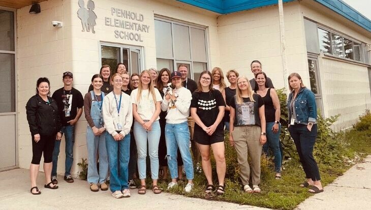 Staff from Penhold Elementary School stand outside of the school